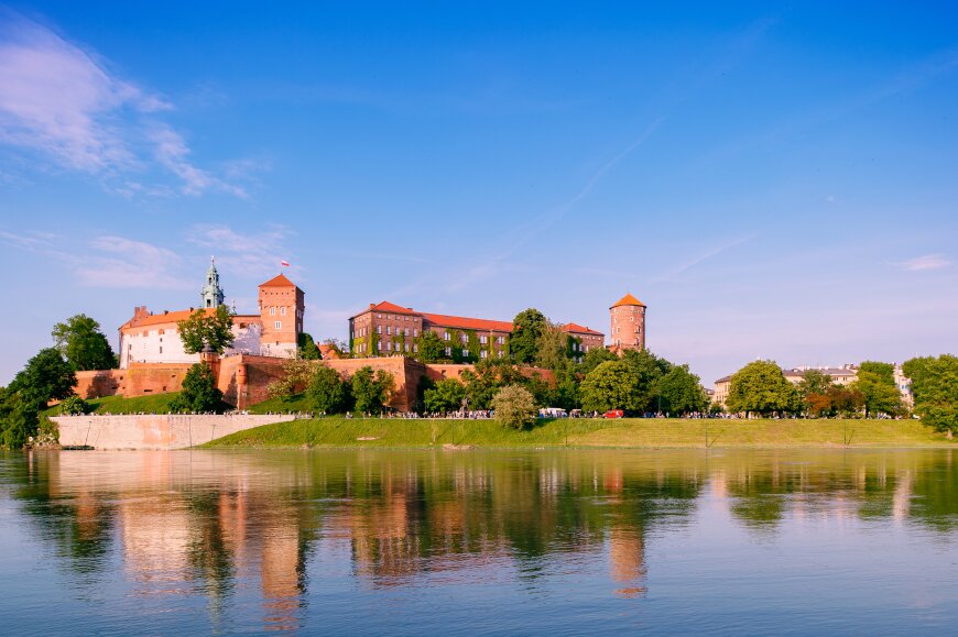 view-at-wawel-castle-in-cracow-city-krakow-poland-reflected-in-vistula-river-wisla-in-sunny-summer-day.jpg